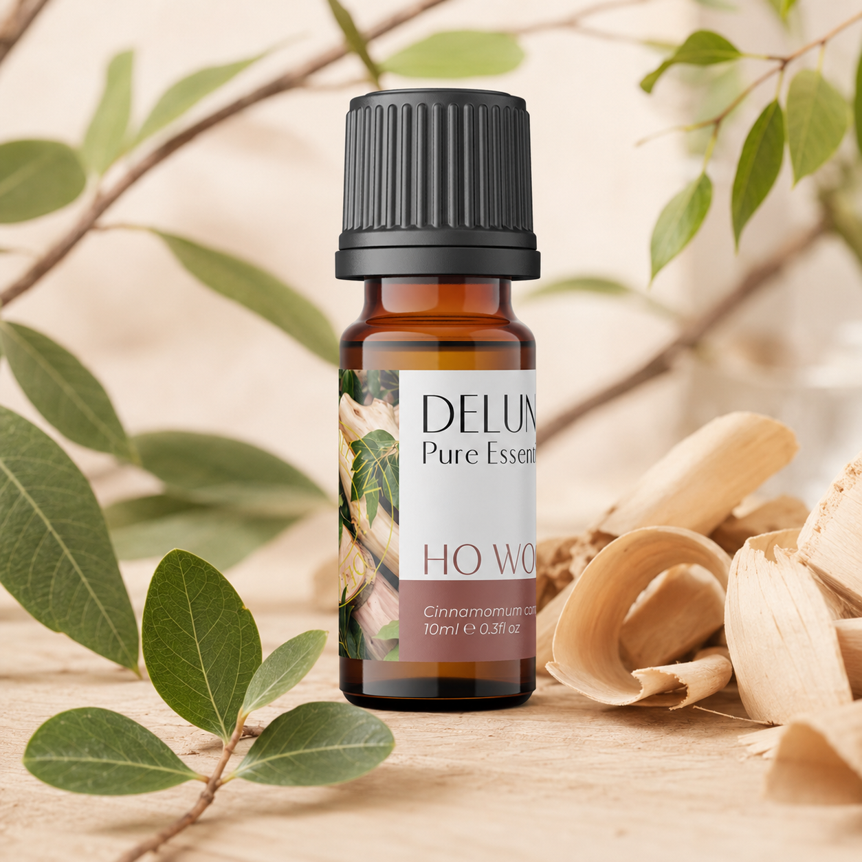 Ho Wood Pure Essential Oil with aromatic wood shavings and green foliage