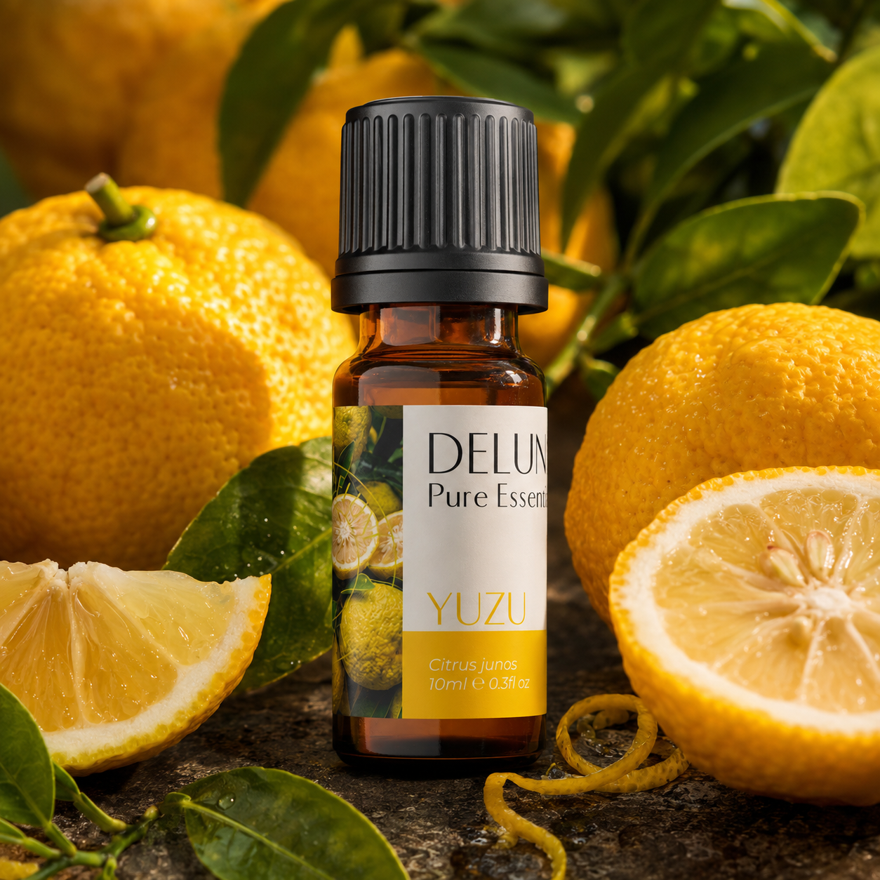 Yuzu Pure Essential Oil with whole and cut yuzu fruit