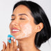 Woman cleansing her face using a Delune face scrubber