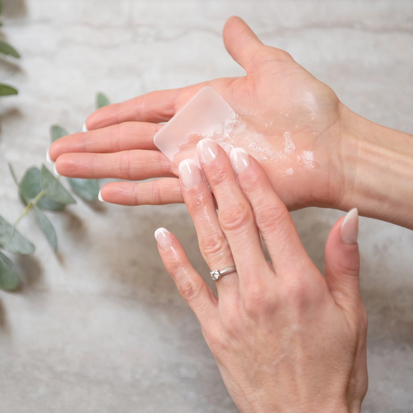 Person using Hand Soap Sheets for a chemical-free, low water lathering wash, shown dissolving on hands with eco-friendly features.